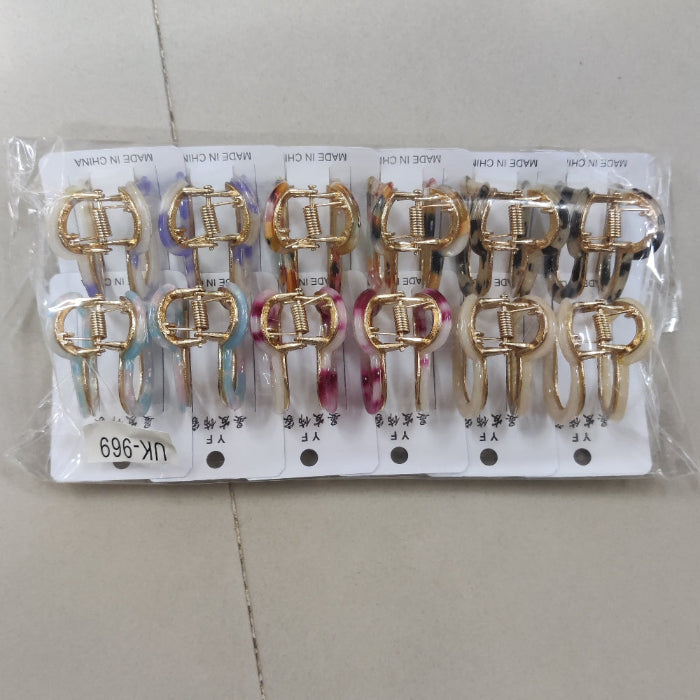 Set of gold and silver hair clips on a clear plastic card with a white background