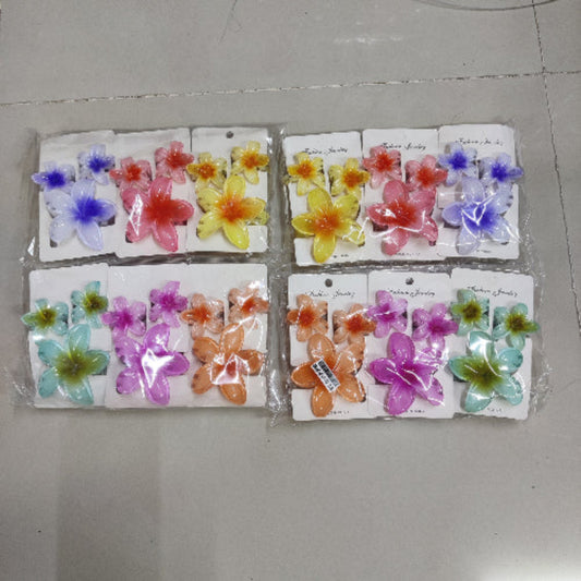 Packaged flower-shaped hair accessories on a gray surface